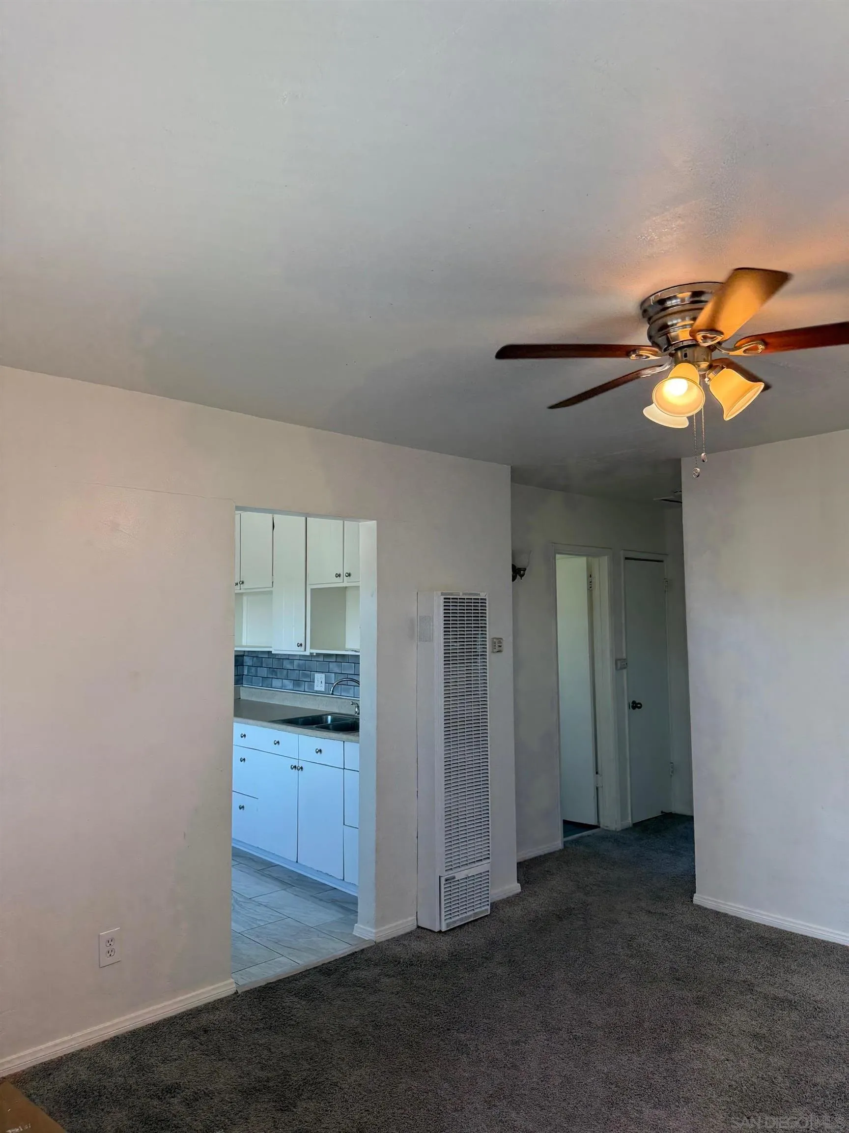 an empty room with closet and windows