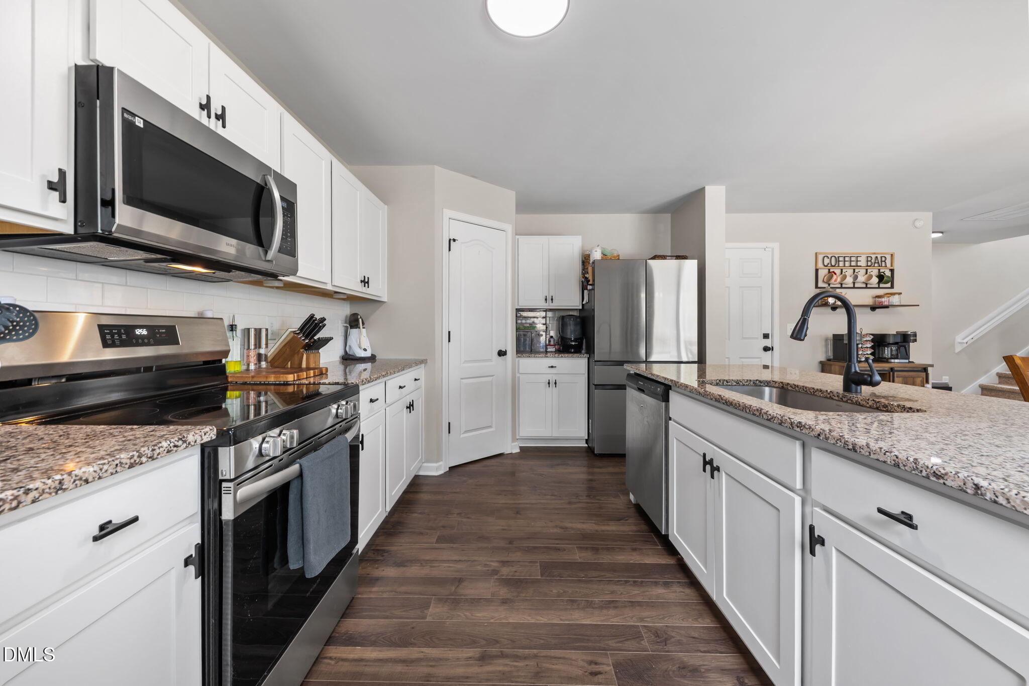 174 Cobra Lane Raeford, NC 28376 - Photo 11 of 32 a kitchen with stainless steel appliances granite countertop a stove top oven a sink dishwasher a refrigerator and a microwave oven with wooden floor