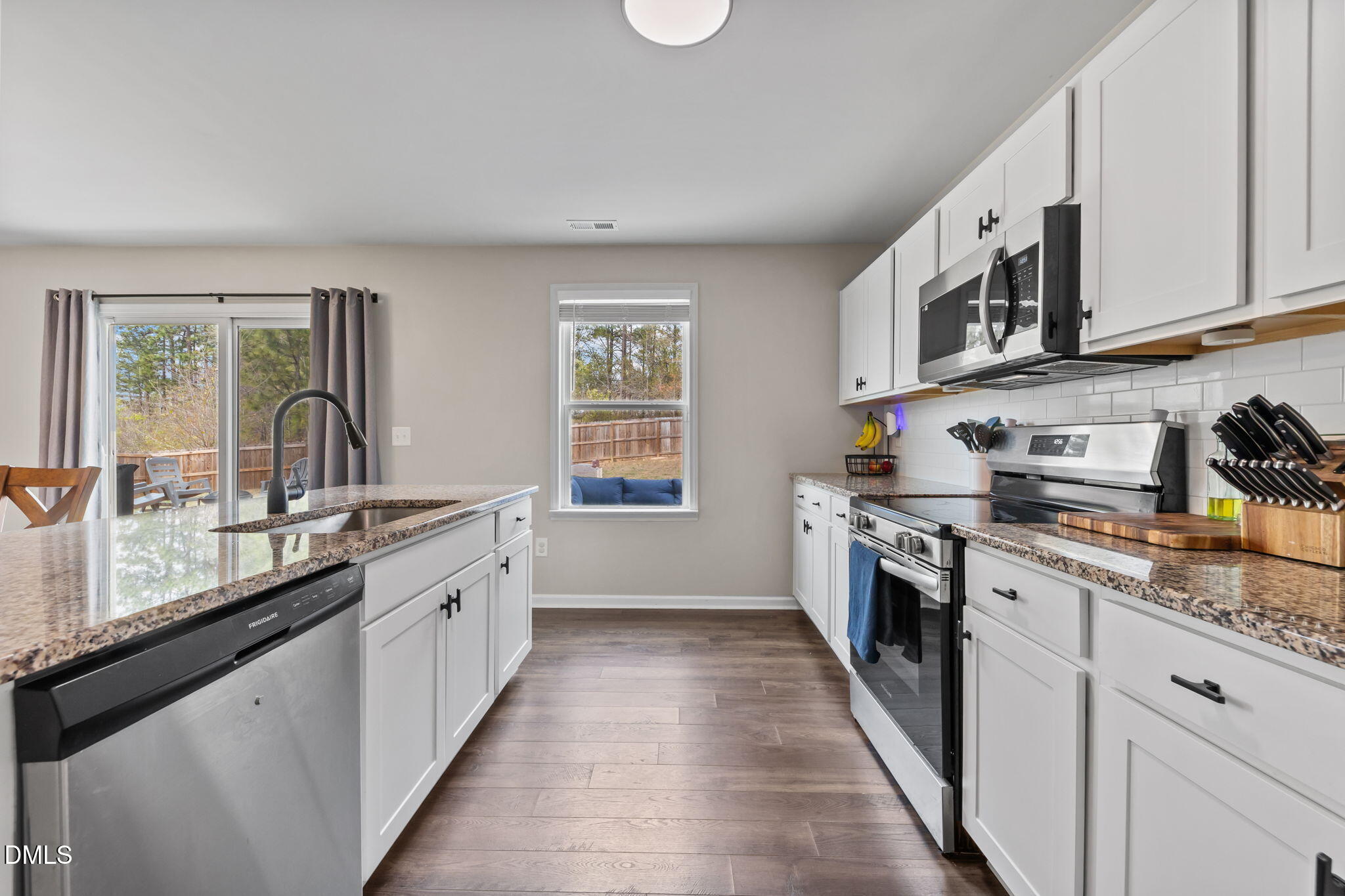 174 Cobra Lane Raeford, NC 28376 - Photo 13 of 32 a large kitchen with stainless steel appliances granite countertop a stove sink and cabinets