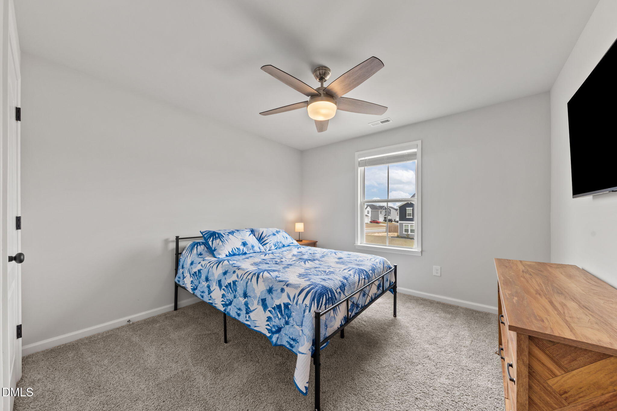 174 Cobra Lane Raeford, NC 28376 - Photo 24 of 32 a bedroom with a bed and a flat screen tv