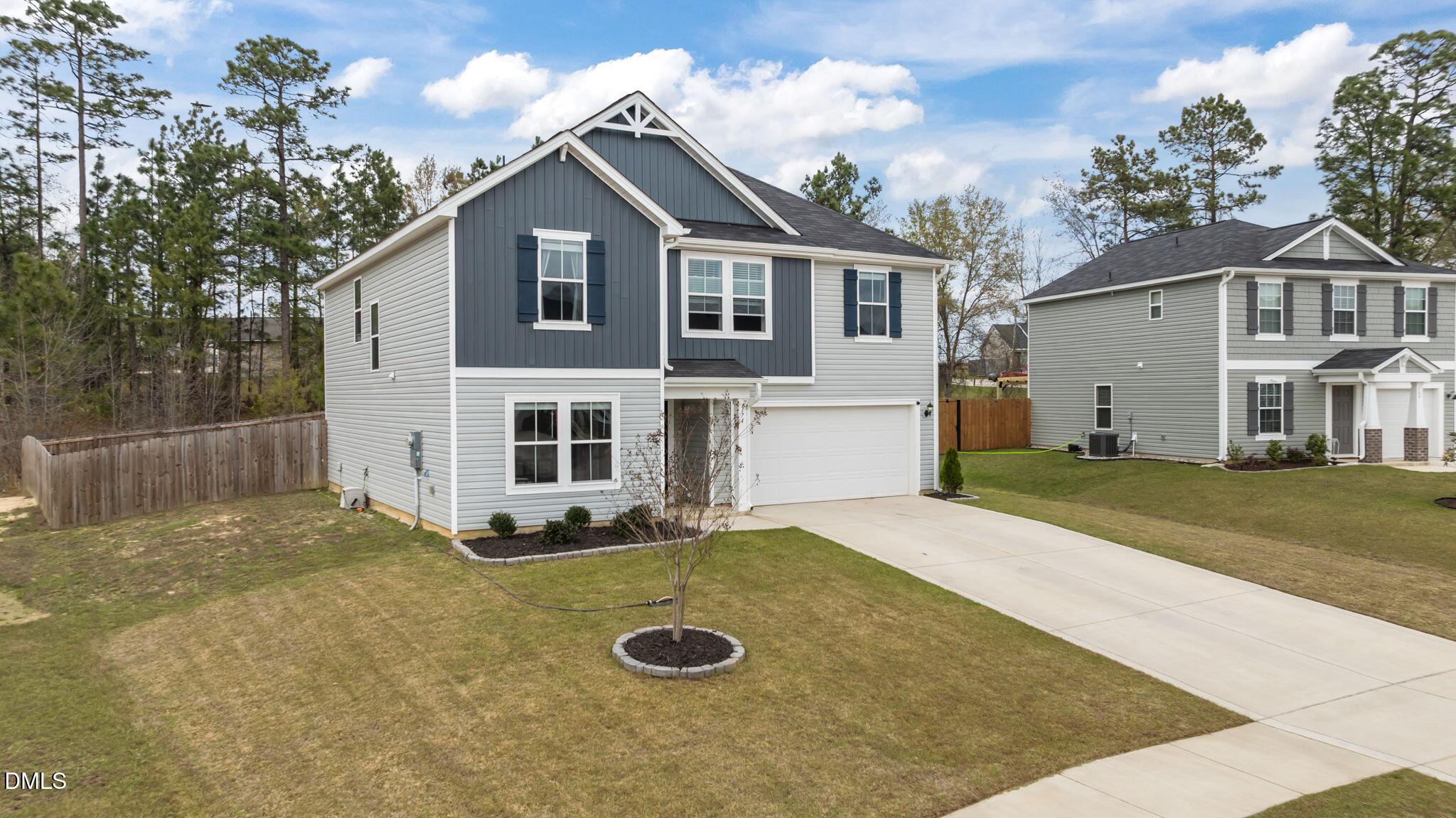 174 Cobra Lane Raeford, NC 28376 - Photo 2 of 32 a front view of a house with yard and garage