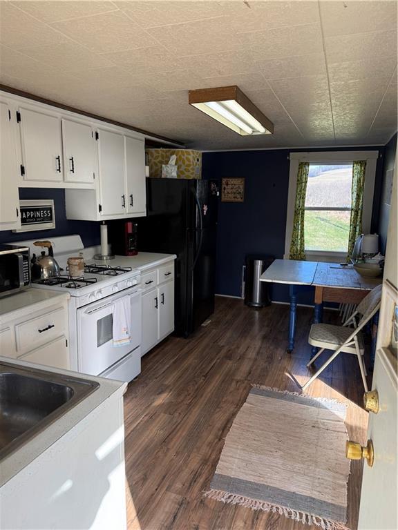 11 Boddorf Road Ringgold, PA 15770 - Photo 6 of 17 a kitchen with stainless steel appliances kitchen island granite countertop a stove a sink and white cabinets