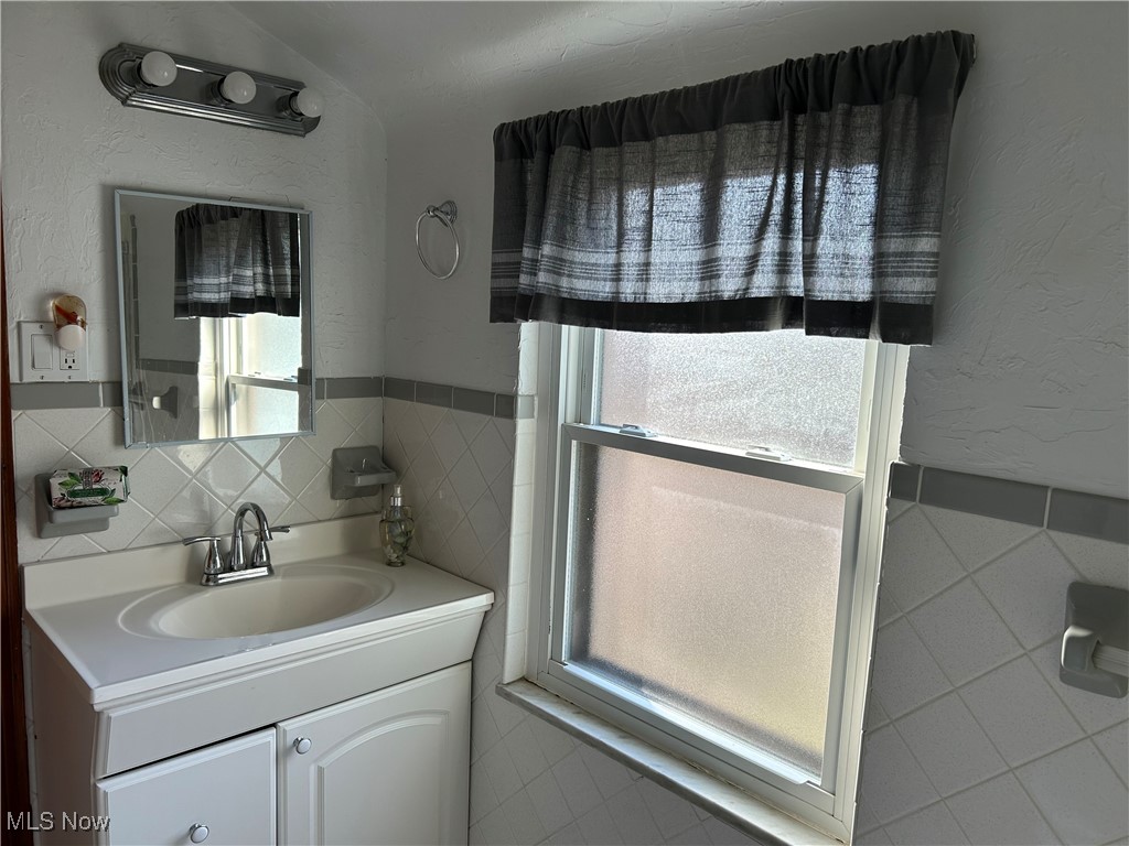 1094 Plainfield Road Cleveland, OH 44121 - Photo 22 of 41 Bathroom featuring plenty of natural light and tile walls