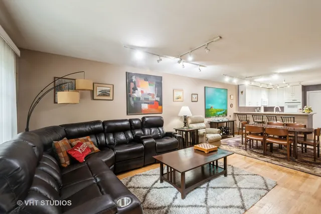 a living room with furniture a kitchen view and a dining table view