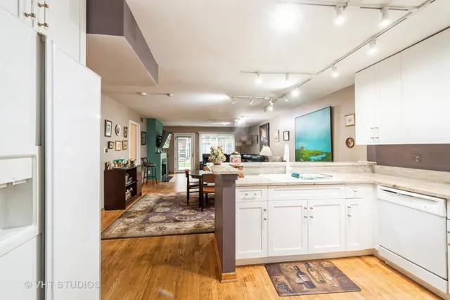 a large kitchen with a sink and cabinets