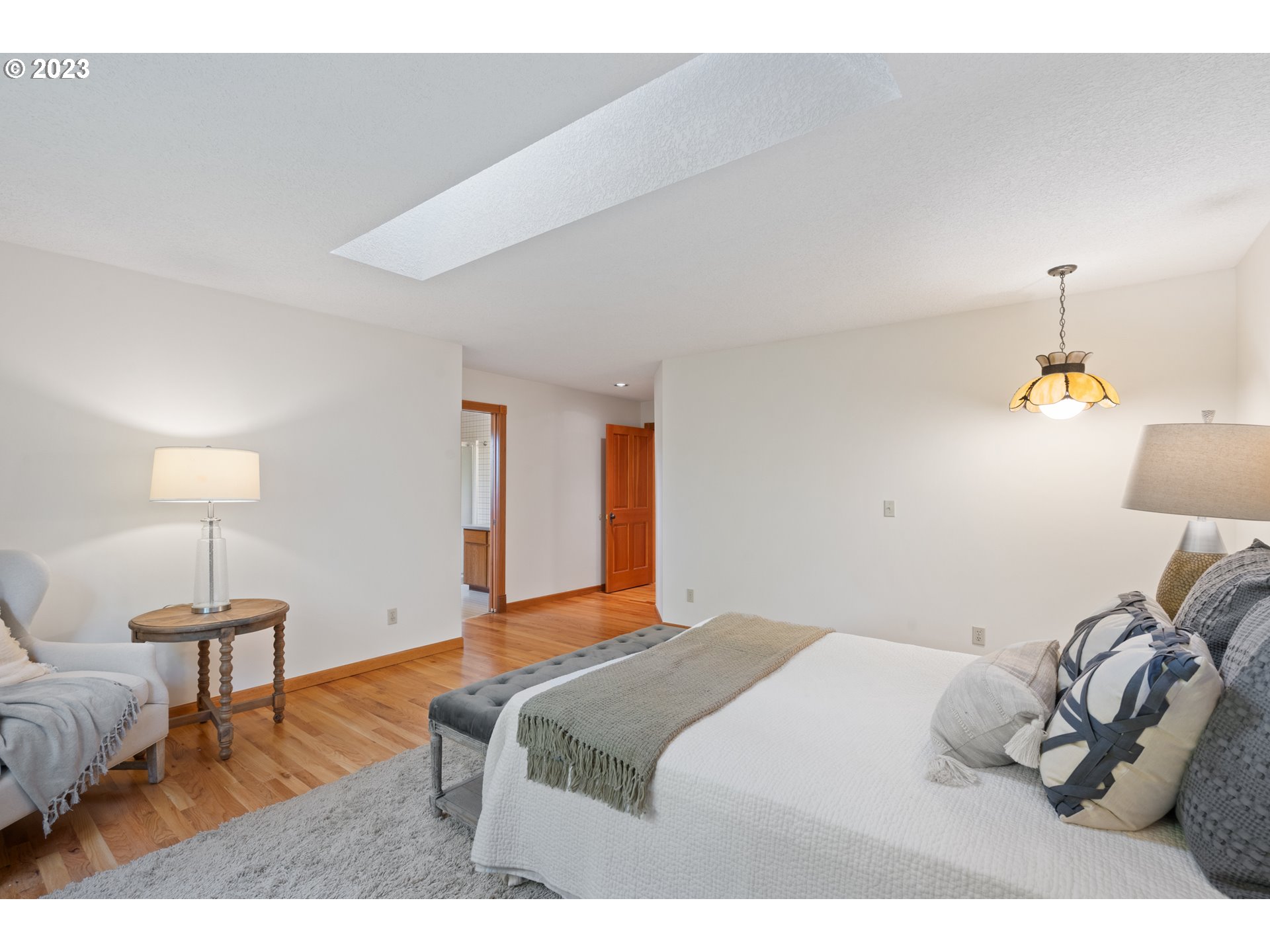 15140 Northwest Gillihan Road Portland, OR 97231 - Photo 20 of 34 a bedroom with a bed and a lamp