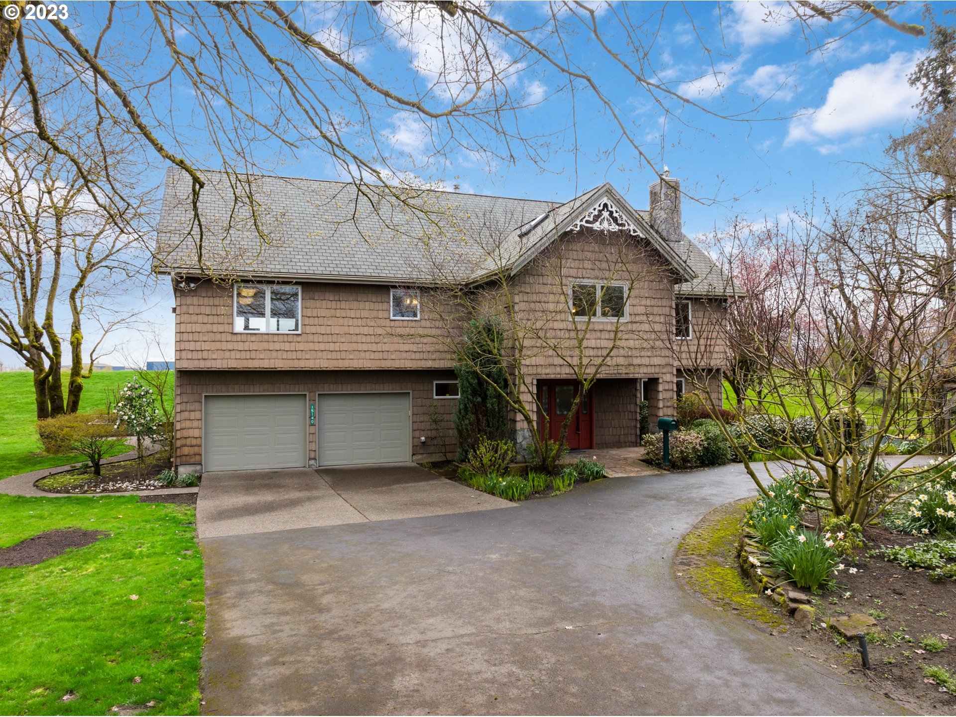 15140 Northwest Gillihan Road Portland, OR 97231 - Photo 2 of 34 a front view of a house with a garden and plants