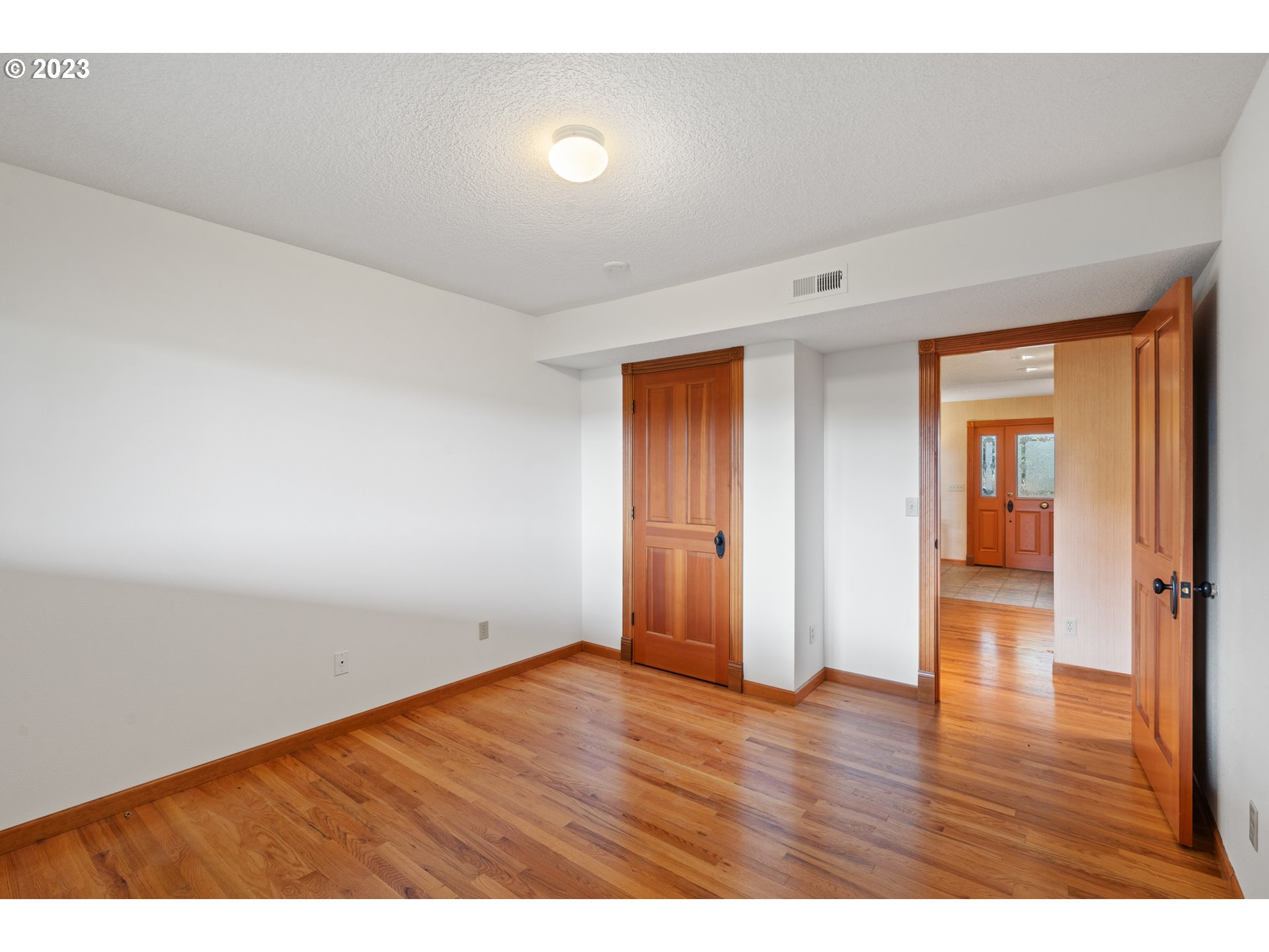 15140 Northwest Gillihan Road Portland, OR 97231 - Photo 23 of 34 a view of an empty room and wooden floor