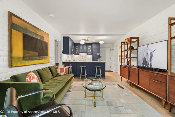 a living room with furniture and kitchen view