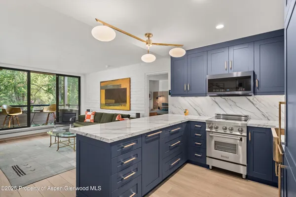 a kitchen with a stove a sink and a refrigerator