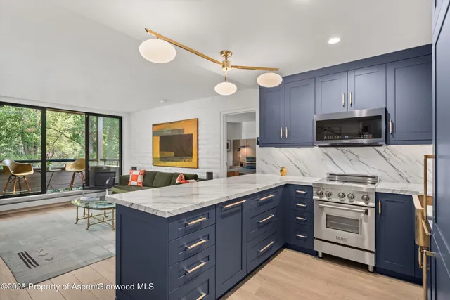 a kitchen with a stove a sink and a refrigerator