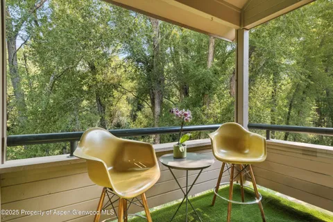 a view of balcony with wooden floor and outdoor seating