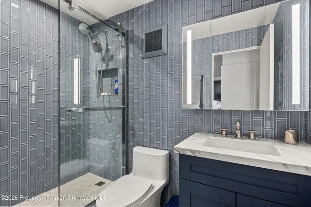 a bathroom with a sink toilet and shower