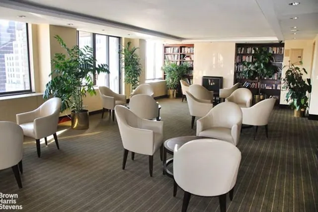 a lobby with furniture and floor to ceiling window