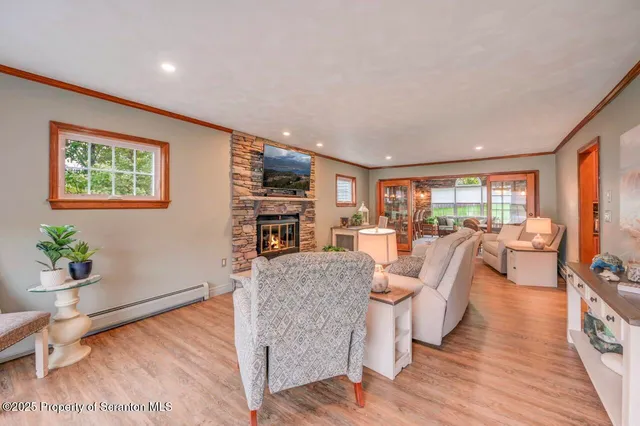 a living room with furniture a large window and a table