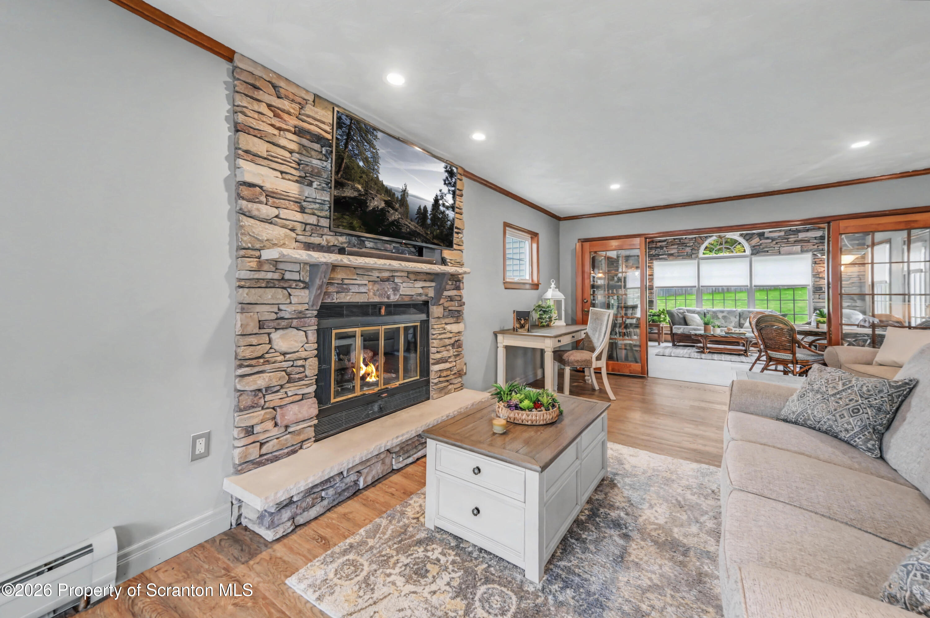 317 Bailey Street Clarks Summit, PA 18411 - Photo 12 of 95 a living room with furniture fireplace and window