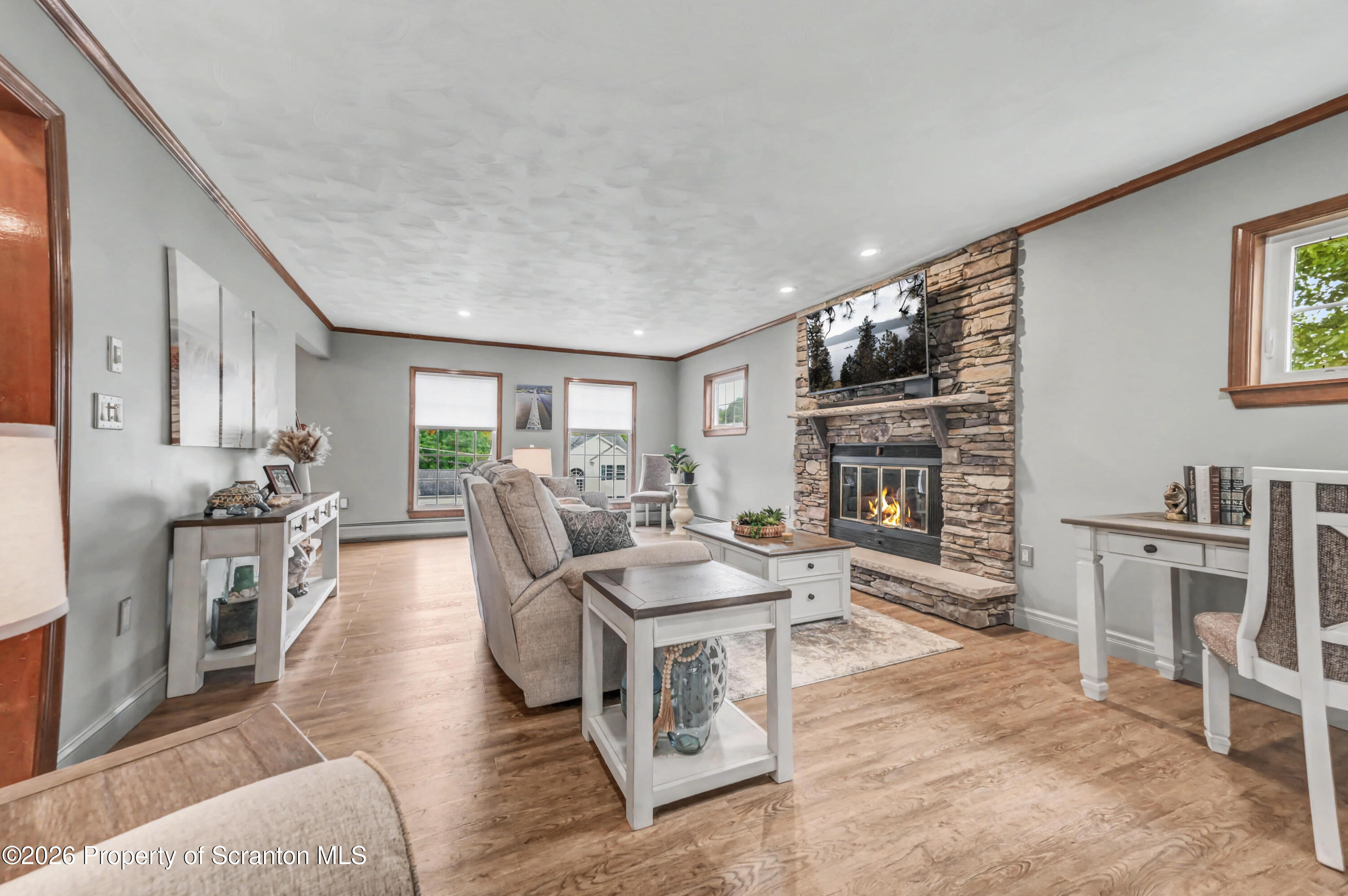 317 Bailey Street Clarks Summit, PA 18411 - Photo 13 of 95 a living room with furniture a fireplace and a flat screen tv
