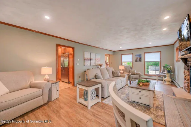 a view of a livingroom with furniture window and wooden floor