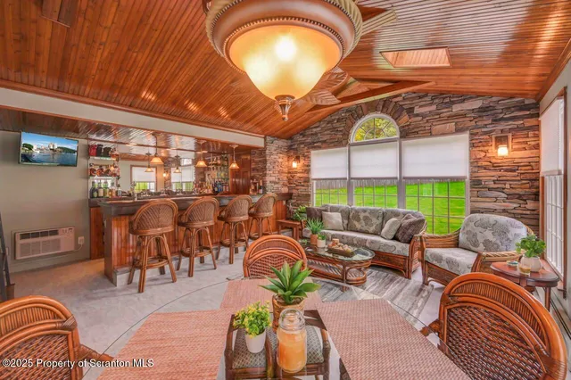 a large kitchen with kitchen island a large window in it