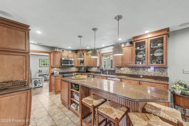 a view of a dining room with furniture a chandelier and wooden floor