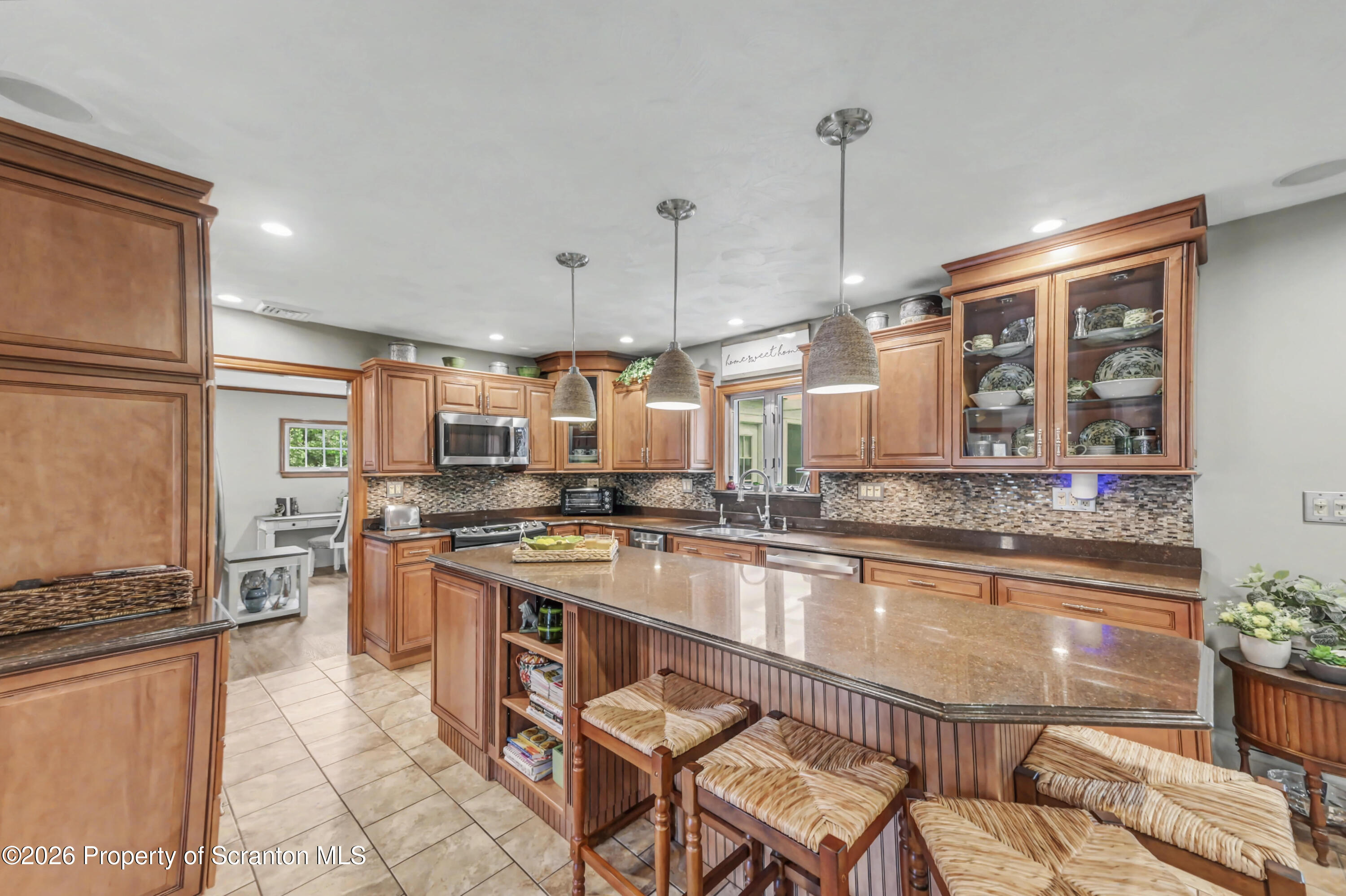 317 Bailey Street Clarks Summit, PA 18411 - Photo 20 of 95 a kitchen with stainless steel appliances granite countertop a stove a sink and a refrigerator