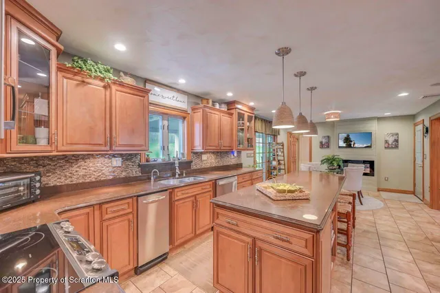 a kitchen with stainless steel appliances granite countertop a sink stove and cabinets