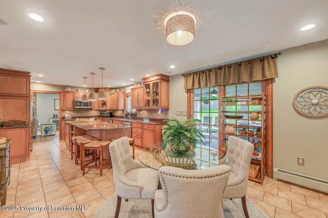 a view of a dining room with furniture a chandelier and wooden floor