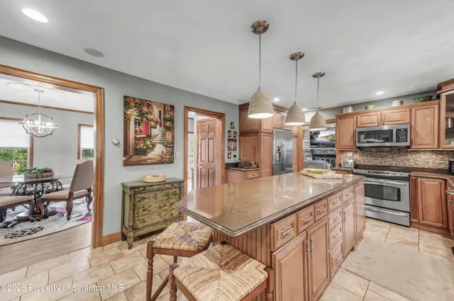 a view of staircase with lots of frames on wall and a potted plant