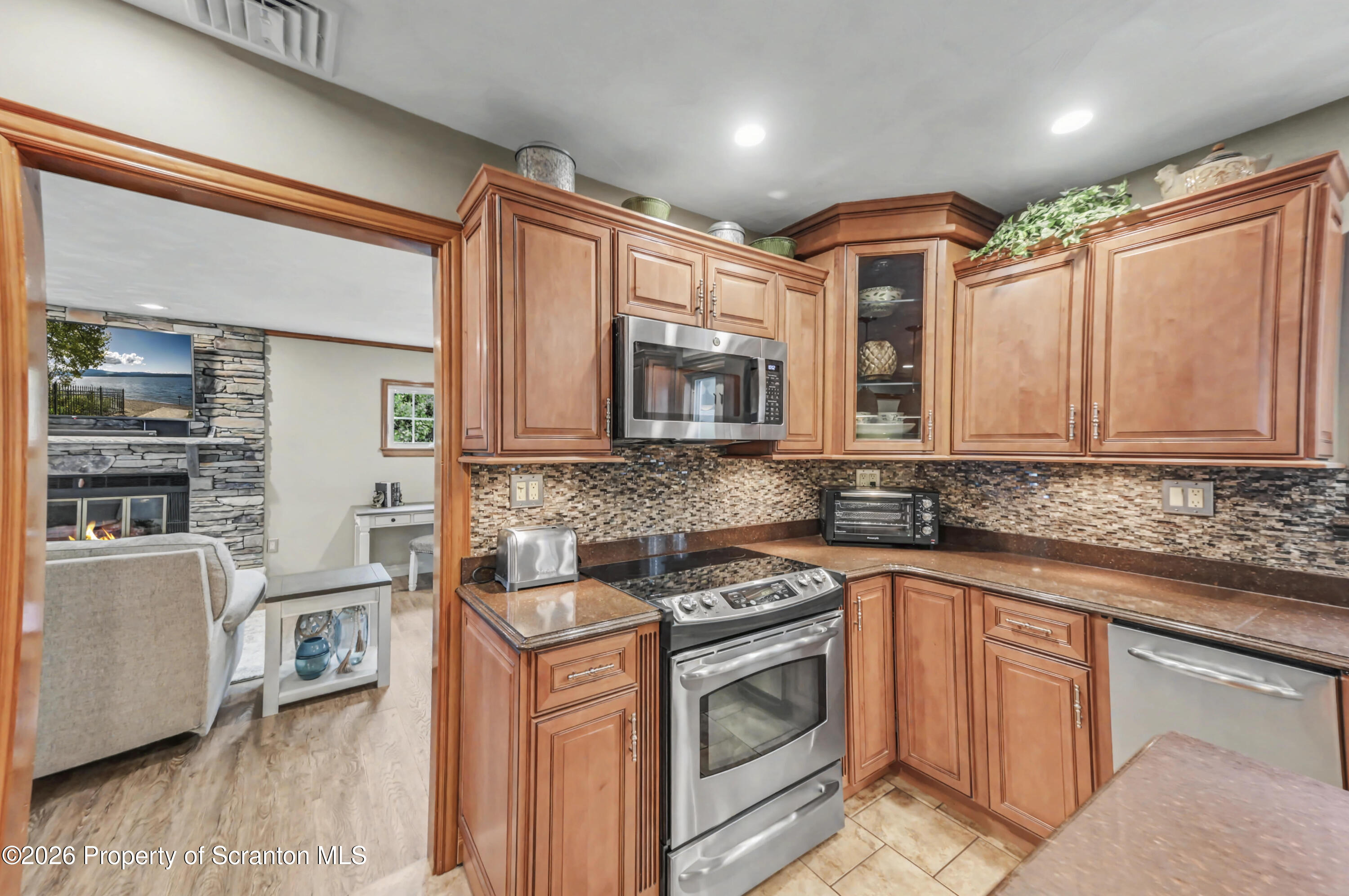 317 Bailey Street Clarks Summit, PA 18411 - Photo 39 of 95 a kitchen with stainless steel appliances granite countertop a sink stove and cabinets