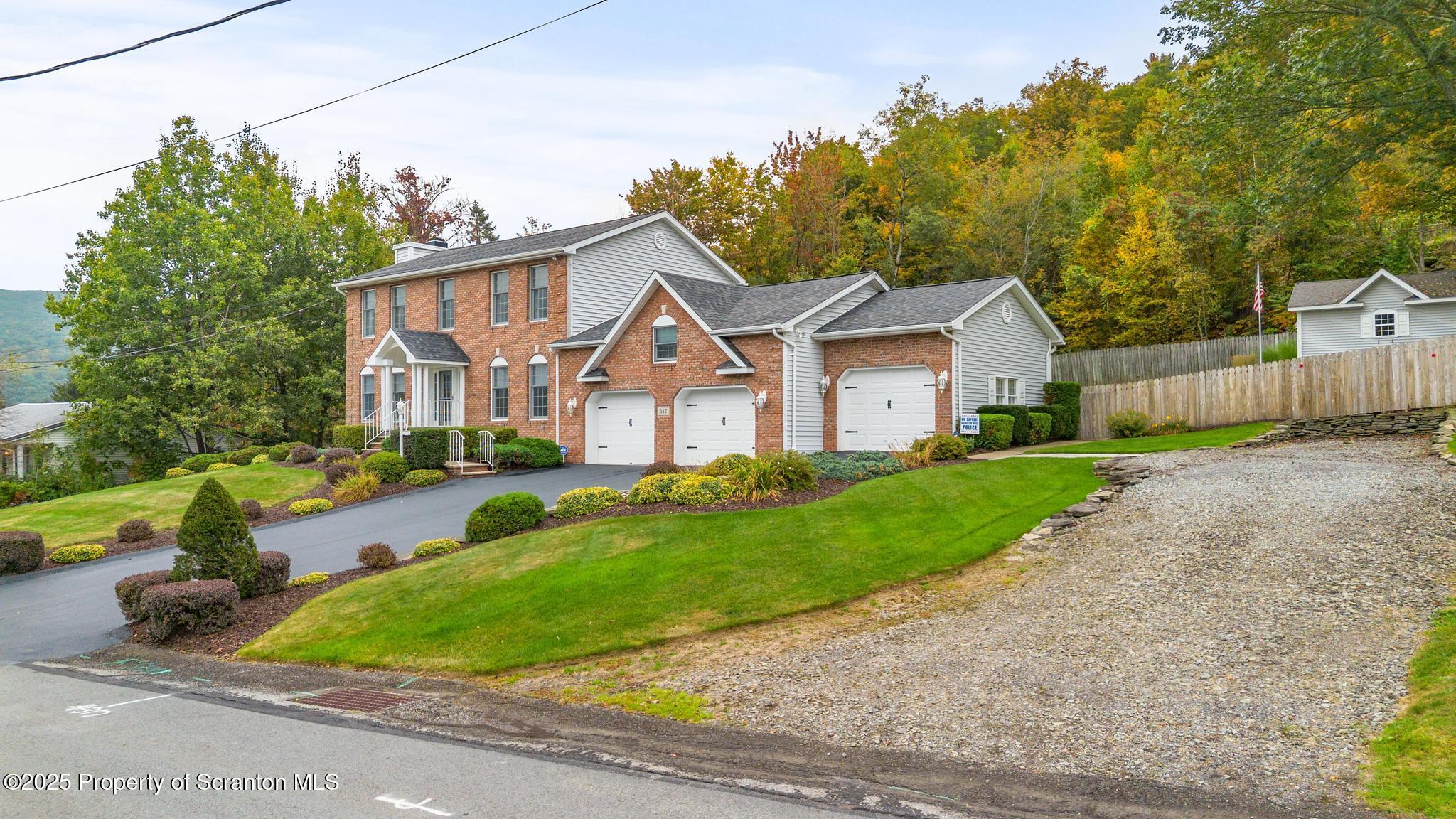 317 Bailey Street Clarks Summit, PA 18411 - Photo 40 of 95 a front view of a house with a yard and trees