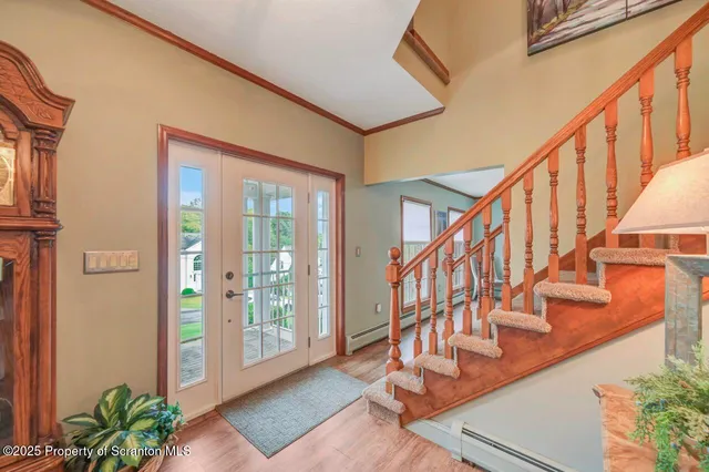 a view of a patio with couches chairs and wooden floor