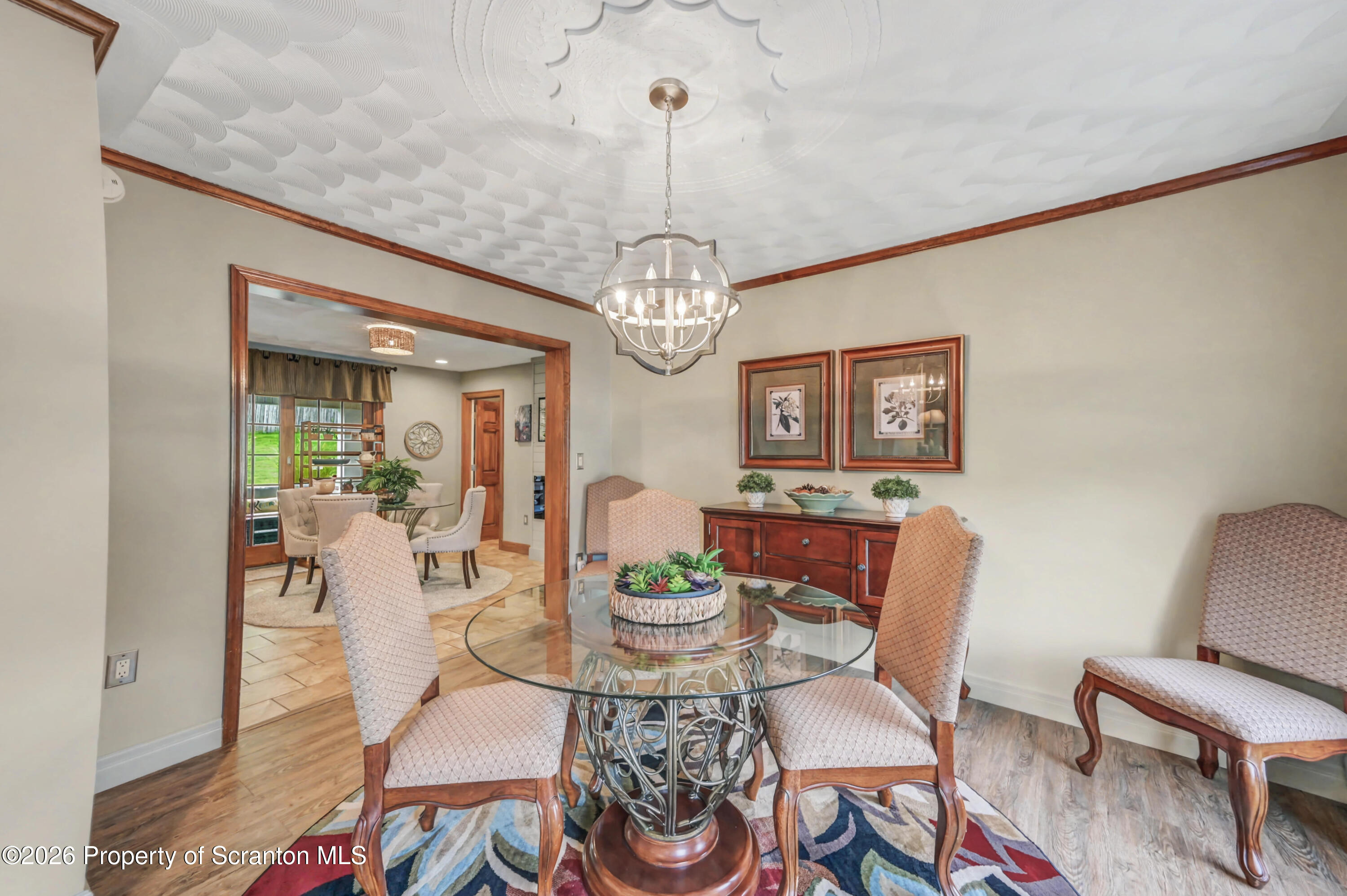 317 Bailey Street Clarks Summit, PA 18411 - Photo 41 of 95 a view of a dining room with furniture a chandelier and wooden floor