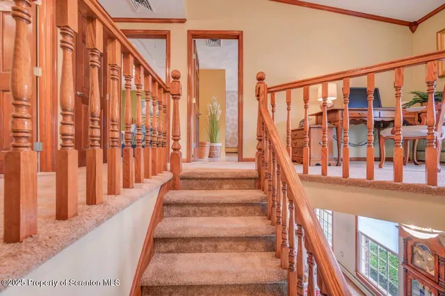 a view of a house next to a big yard and large trees