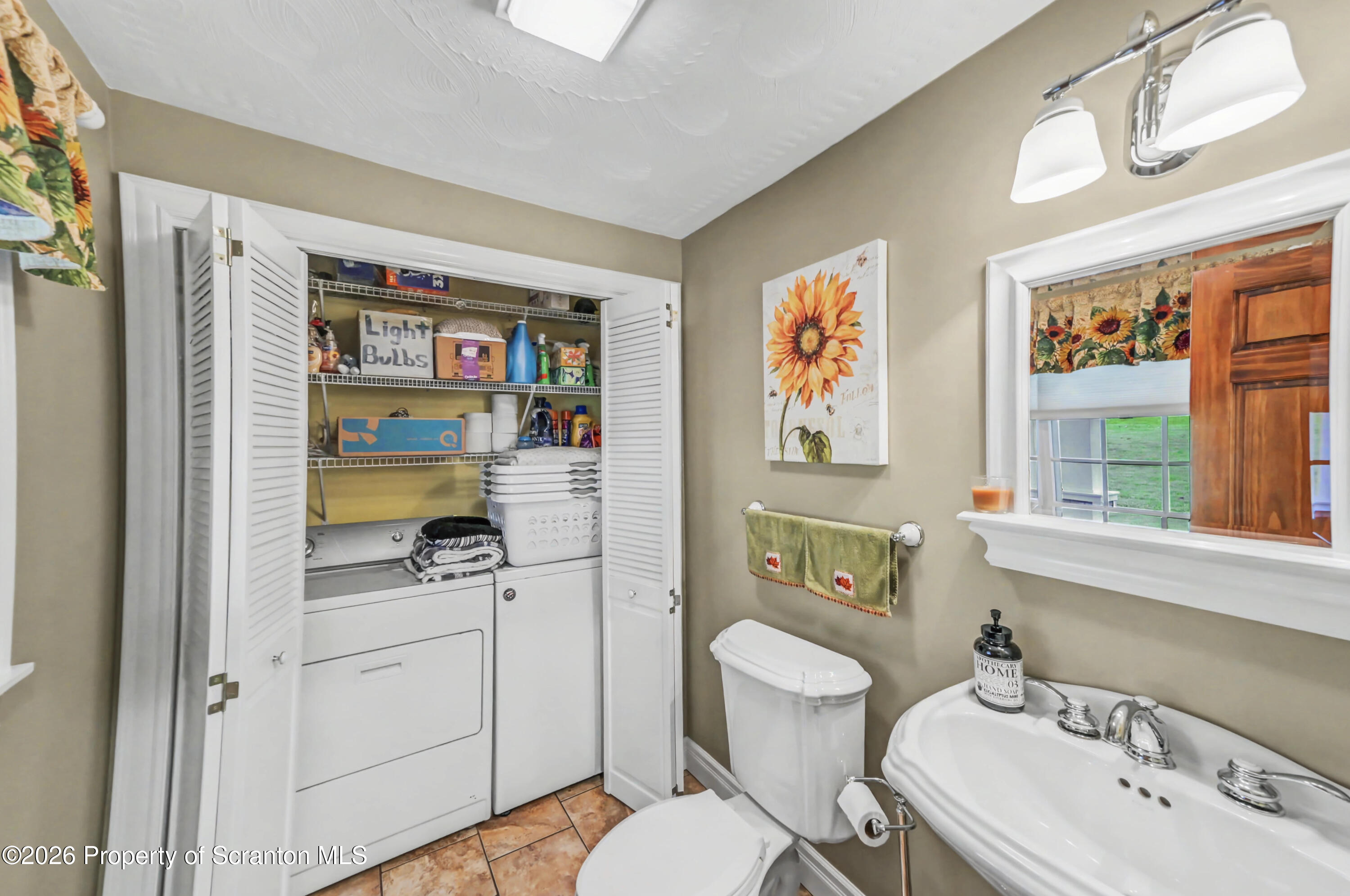 317 Bailey Street Clarks Summit, PA 18411 - Photo 47 of 95 a bathroom with a sink a toilet and a shower curtain
