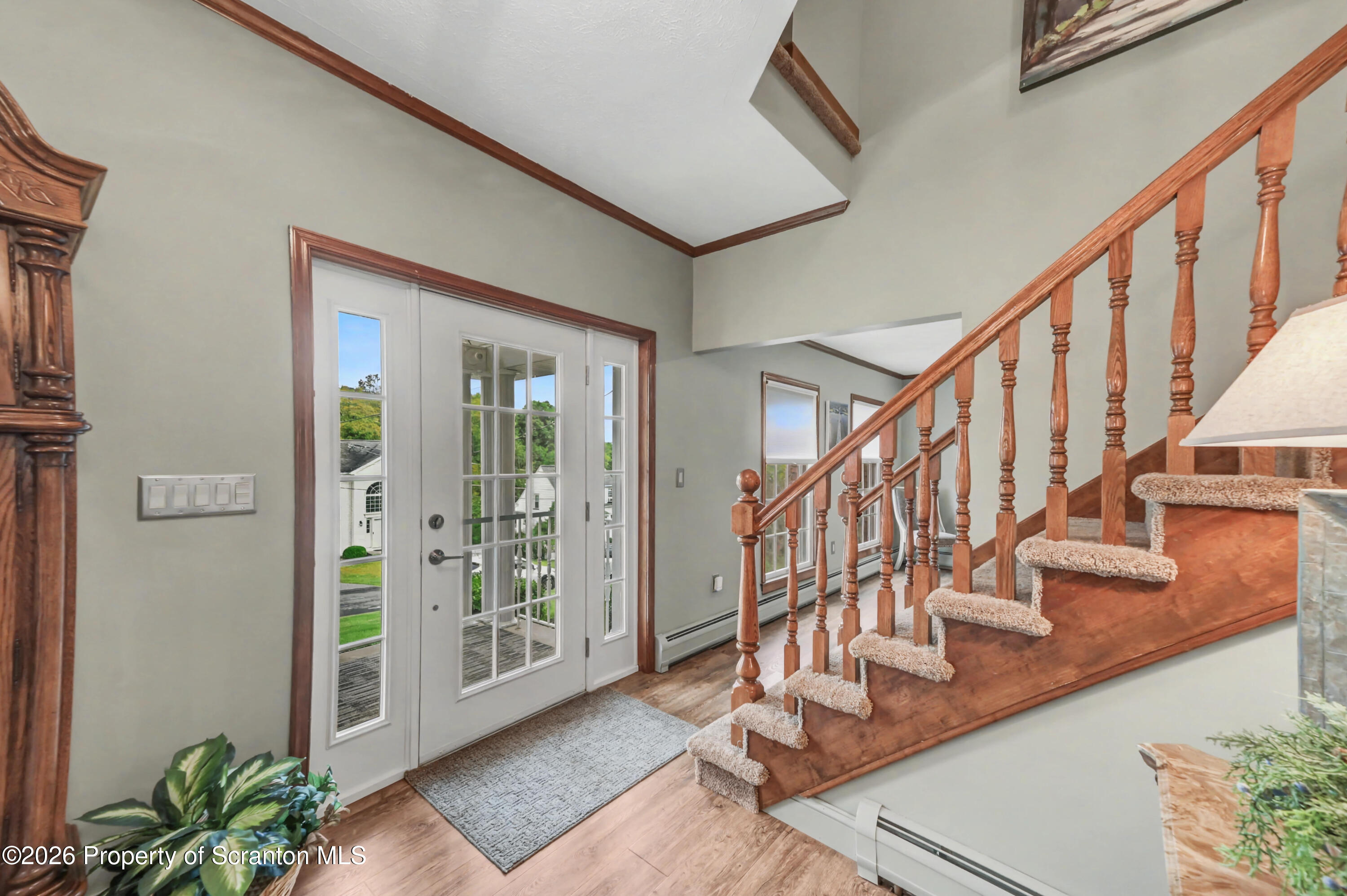 317 Bailey Street Clarks Summit, PA 18411 - Photo 48 of 95 a view of staircase with lots of frames on wall and a potted plant