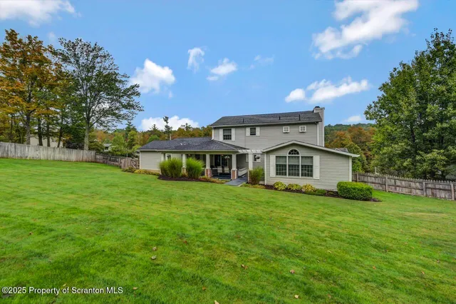 a living room with patio furniture and a large window