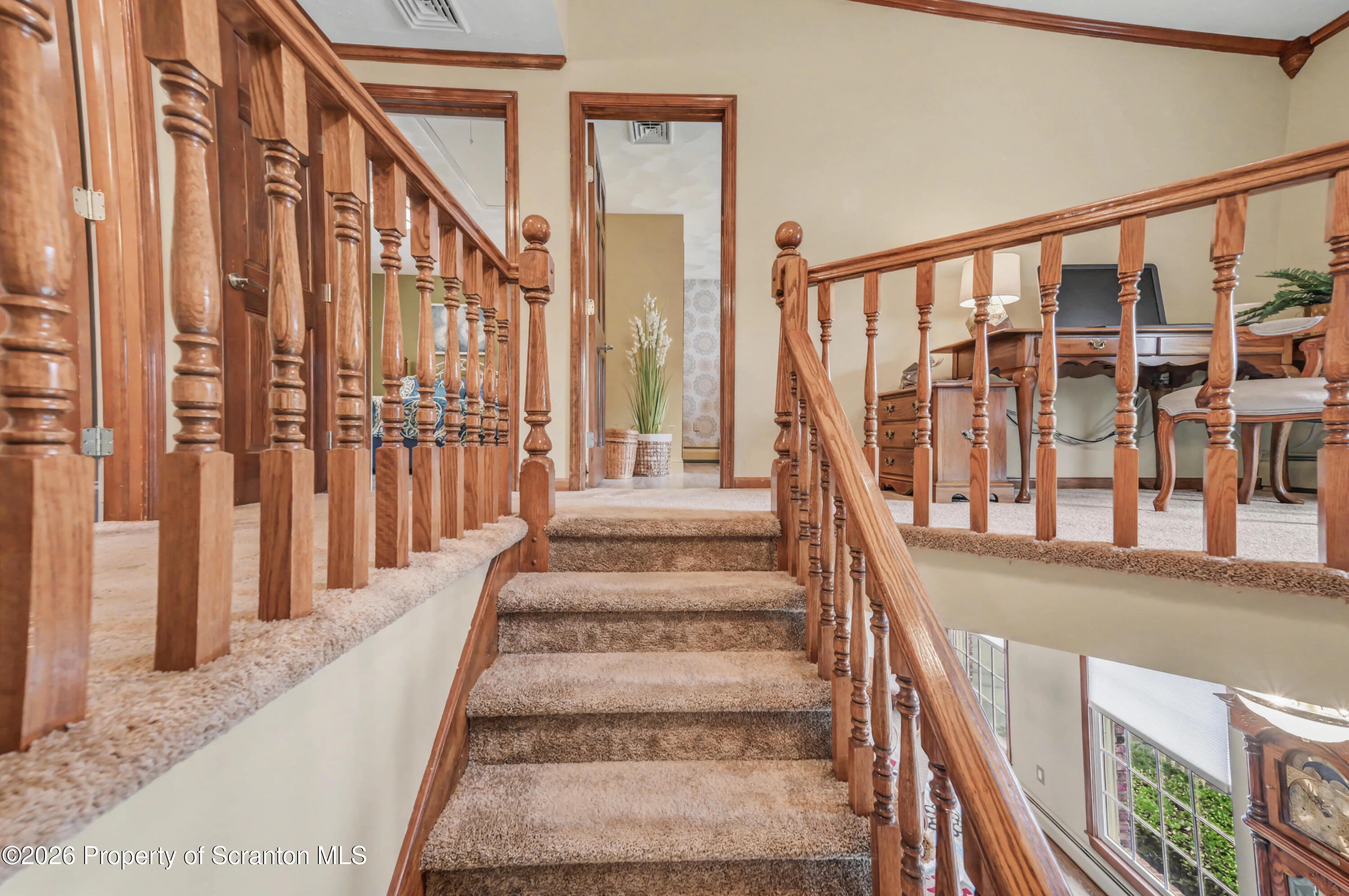317 Bailey Street Clarks Summit, PA 18411 - Photo 52 of 95 a view of staircase with lots of frames on wall and a large window