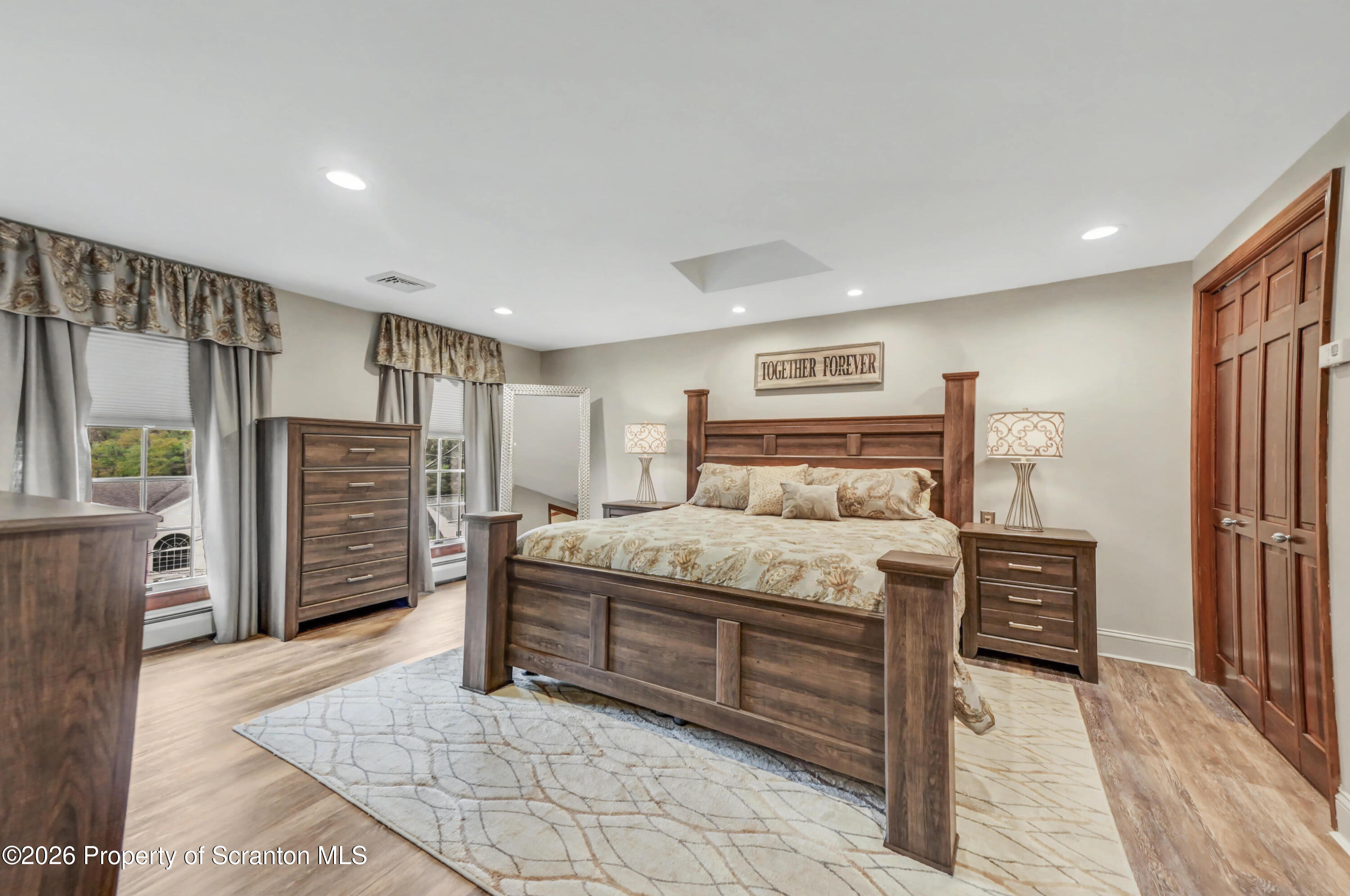 317 Bailey Street Clarks Summit, PA 18411 - Photo 55 of 95 a bedroom with a bed closet and flat screen tv