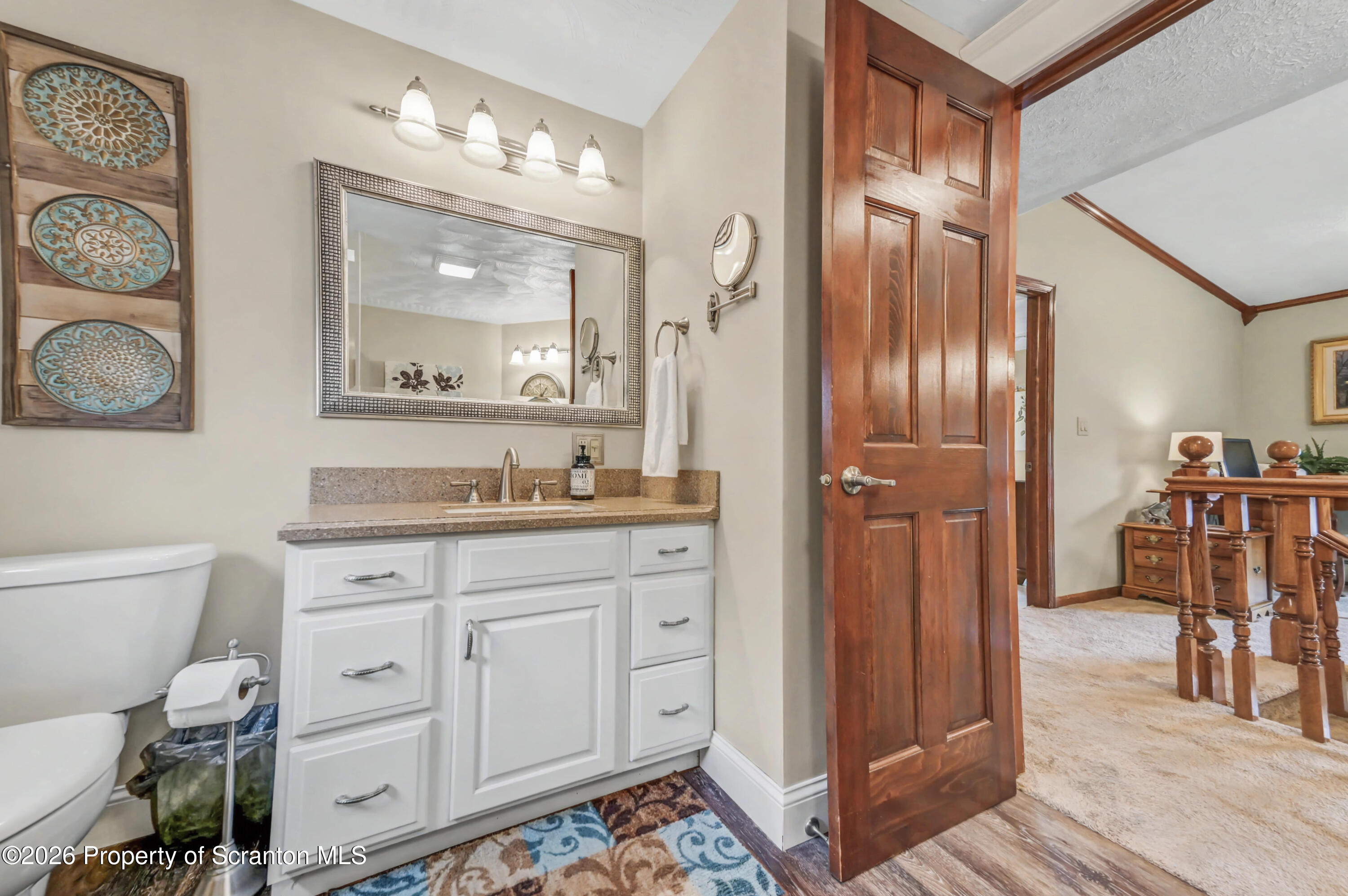 317 Bailey Street Clarks Summit, PA 18411 - Photo 66 of 95 a spacious bathroom with a granite countertop sink mirror and vanity