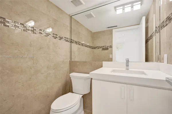 a spacious bathroom with a double vanity sink mirror and shower