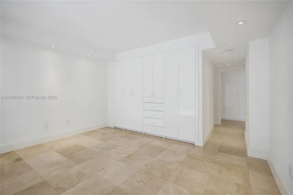 a view of a porch with wooden floor and iron fence