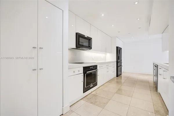 a kitchen with granite countertop cabinets and steel stainless steel appliances