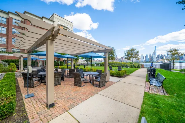 a view of a patio with a table and chairs under an umbrella