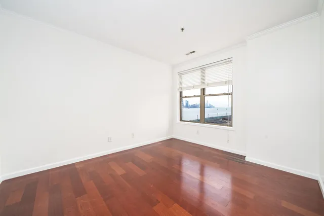 an empty room with windows and closet