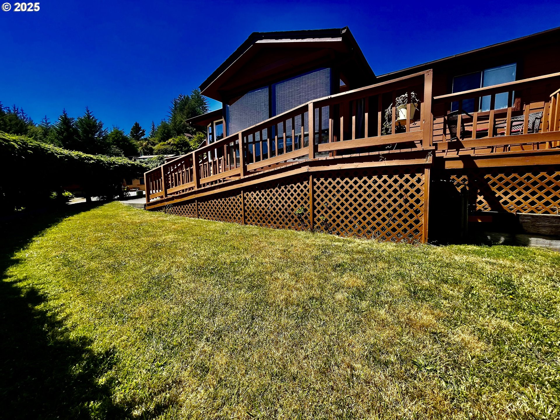 a view of a house with a wooden deck