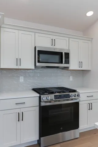 a stove top oven sitting inside of a kitchen