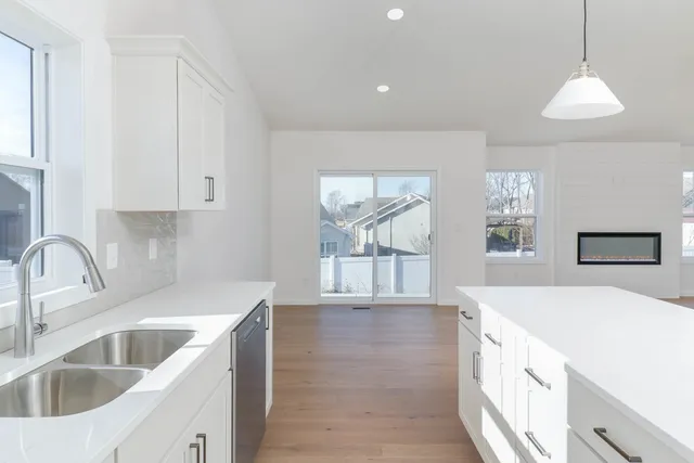 a kitchen with granite countertop a sink and a stove top oven
