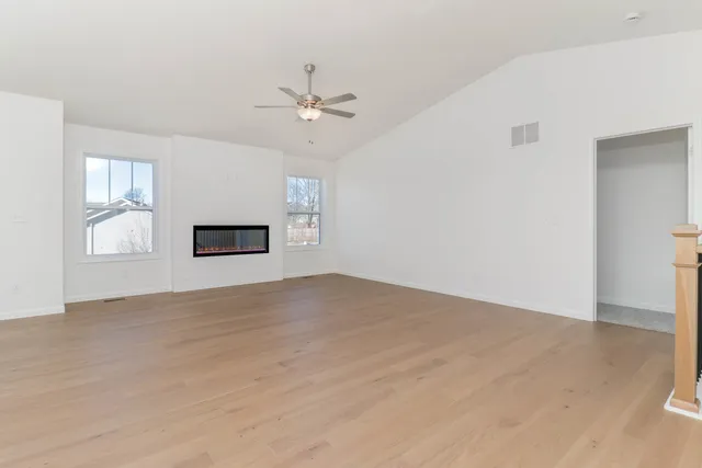 a view of empty room with a fireplace