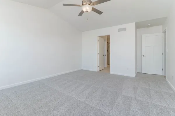 a view of an empty room with a ceiling fan