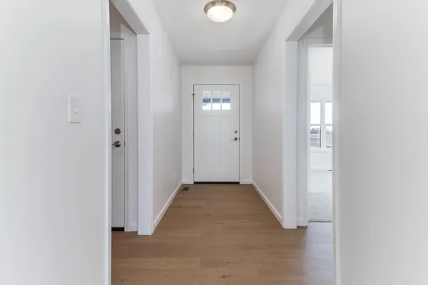 a view of a hallway with wooden floor
